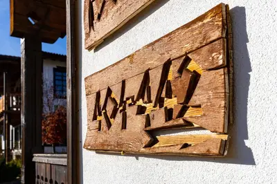 a wooden sign on the side of a building at Vacation Apartment in Starosel complex in Starosel