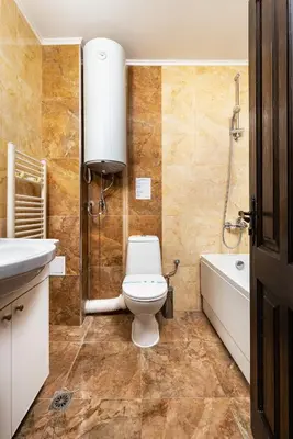 a bathroom with a toilet and a sink and a tub at Vacation Apartment in Starosel complex in Starosel