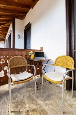 two chairs sitting next to a desk with a computer at Vacation Apartment in Starosel complex in Starosel