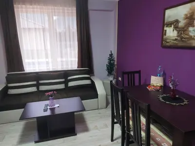 a living room with a couch and a table at Вилен комплекс Дарибел in Sapareva Banya
