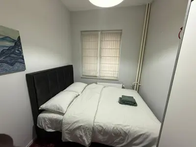 a small bedroom with a bed with a book on it at Central Elegance NDK 3BDR in Sofia