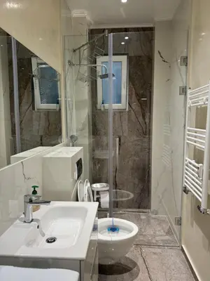 a bathroom with a sink and a shower and a toilet at Central Elegance NDK 3BDR in Sofia