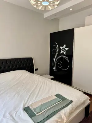 a bedroom with a bed with a green towel on it at Central Elegance NDK 3BDR in Sofia