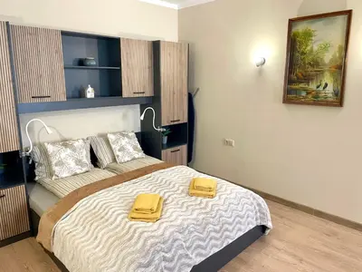 a bedroom with a bed with two yellow towels on it at 1BR Apartment Near Gondola by SI Stay in Bansko