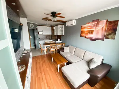 a living room with a couch and a table at Belvedere Holiday Club H70 in Bansko