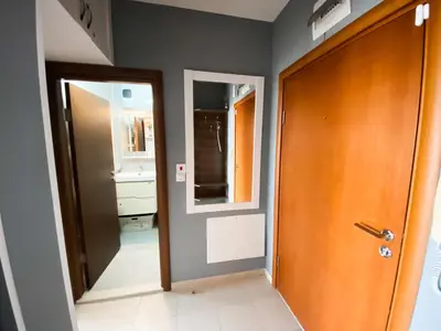 a hallway with a door and a mirror at Belvedere Holiday Club H70 in Bansko
