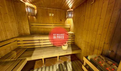 a wooden sauna with a sign in the middle at Belvedere Holiday Club H70 in Bansko