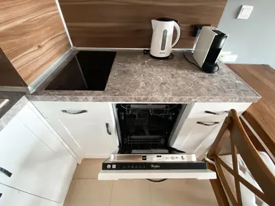 a kitchen with a counter top with a stove at Belvedere Holiday Club H70 in Bansko