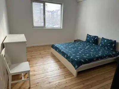 a small bedroom with a bed and a window at Апартамент 21 in Sofia