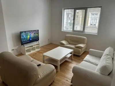 a living room with two couches and a tv at Апартамент 21 in Sofia
