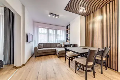 a living room with a table and chairs and a couch at Alpine Hideaway at The Castle in Smolyan