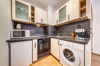 a kitchen with a washing machine and a washer and dryer at Alpine Hideaway at The Castle in Smolyan