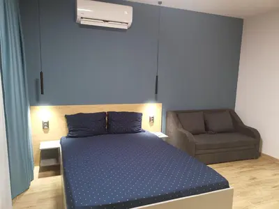 a bedroom with a blue bed and a chair at West Park in Sofia