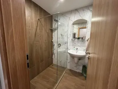 a bathroom with a shower and a sink at RIA studio in Borovets Gardens hotel in Borovets