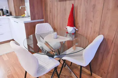 a santa hat sitting on a table in a kitchen at Apartment Dream - Comfort & Calm in Pirin Sense by Flat Mаnаger in Bansko