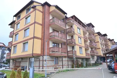 a large building with balconies on the side of it at Apartment Dream - Comfort & Calm in Pirin Sense by Flat Mаnаger in Bansko