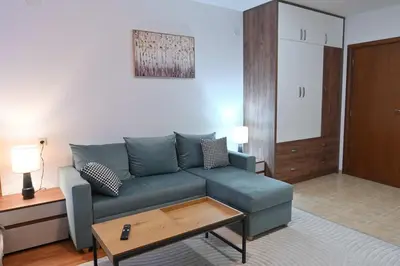 a living room with a blue couch and a table at Apartment Dream - Comfort & Calm in Pirin Sense by Flat Mаnаger in Bansko