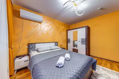 a bedroom with a bed with two white towels on it at Ski-Friendly Family Getaway in Pamporovo