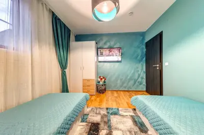 two beds in a bedroom with blue walls at Ski-Friendly Family Getaway in Pamporovo