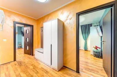 a hallway with orange walls and a white door at Ski-Friendly Family Getaway in Pamporovo