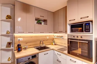 a kitchen with white cabinets and a sink and a microwave at Ski-Friendly Family Getaway in Pamporovo