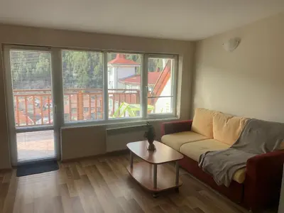 a living room with a couch and a table at Rooftop apartment with stunning view in Beli Iskar