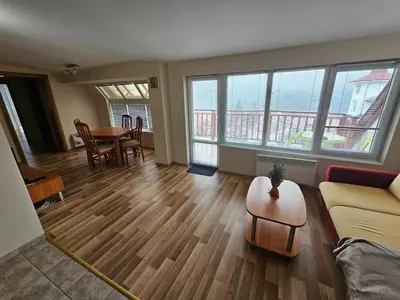 a living room with a couch and a table at Rooftop apartment with stunning view in Beli Iskar