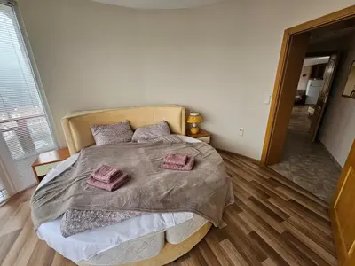 a bedroom with a large bed with two pillows on it at Rooftop apartment with stunning view in Beli Iskar