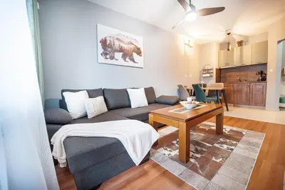 a living room with a couch and a table at 400m from Ski Belvedere Apartment - Free Parking - SPA in Bansko
