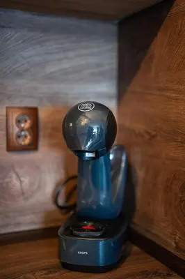 a blue coffee maker sitting on a table at 400m from Ski Belvedere Apartment - Free Parking - SPA in Bansko