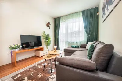 a living room with a couch and a tv at 400m from Ski lift Belvedere Apartment - SPA - Free parking in Bansko