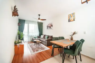 a living room with a table and a couch at 400m from Ski lift Belvedere Apartment - SPA - Free parking in Bansko
