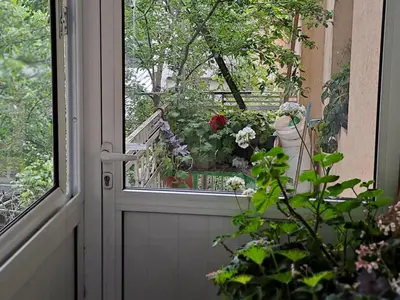 a door with a bunch of flowers in a window at Guest House The House in Plovdiv