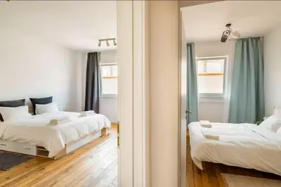 a bedroom with two beds and a mirror at Cozy 2BDR Balcony Apt with View in Historic Center in Sofia
