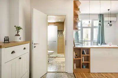 a kitchen with white cabinets and a white refrigerator at Cozy 2BDR Balcony Apt with View in Historic Center in Sofia