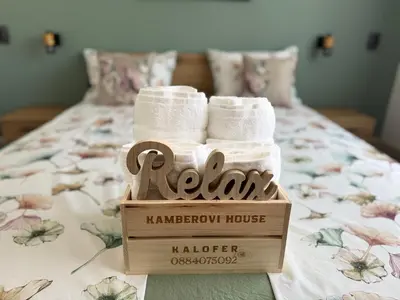 two rolls of towels in a wooden box on a bed at Къща Камберови град Калофер in Kalofer