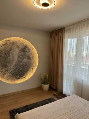 a bedroom with a large planet on the wall at Plovdiv Moon - 1 Bedroom Luxury Apartment in Plovdiv