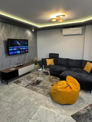 a living room with a couch and a tv at Plovdiv Moon - 1 Bedroom Luxury Apartment in Plovdiv