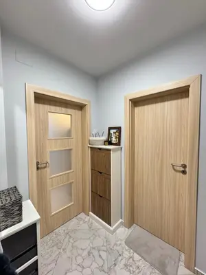 a room with two wooden doors and a counter at Plovdiv Moon - 1 Bedroom Luxury Apartment in Plovdiv