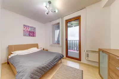 a bedroom with a bed and a window at Alpine Comfort at Grand Monastery in Pamporovo