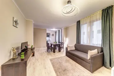 a living room with a couch and a table at Warm Mountain Hideout in Pamporovo