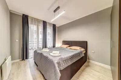 a bedroom with a bed with two plates on it at Warm Mountain Hideout in Pamporovo