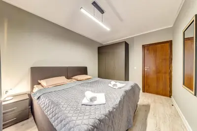 a bedroom with a bed with two towels on it at Warm Mountain Hideout in Pamporovo