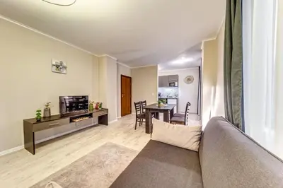a living room with a couch and a table at Warm Mountain Hideout in Pamporovo