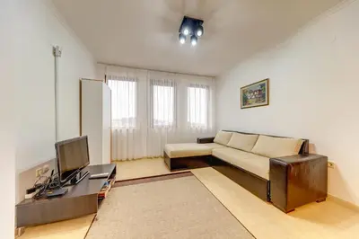 a living room with a couch and a tv at Slopeview Stay at Grand Monastery in Pamporovo