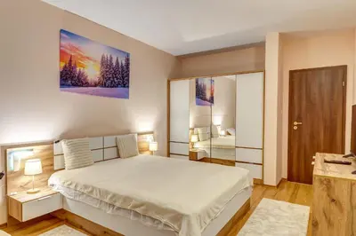 a bedroom with a large white bed in a room at Cozy Evrika 2 Mountain Home in Pamporovo
