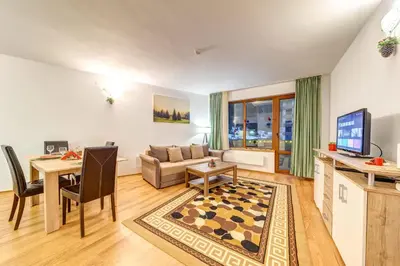 a living room with a couch and a table at Cozy Evrika 2 Mountain Home in Pamporovo