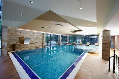a large swimming pool in a hotel room at Sunlit Forest Suite in Borovets