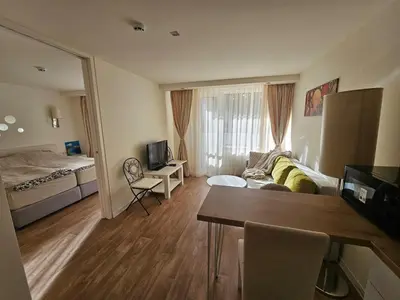 a living room with a couch and a bed at Sunlit Forest Suite in Borovets