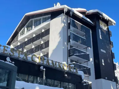 a building with a sign on the side of it at Sunlit Forest Suite in Borovets